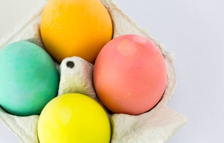 Multicolour Easter eggs in bright light on white background