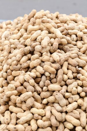 Large group pf peanuts on market for sale close up background shot