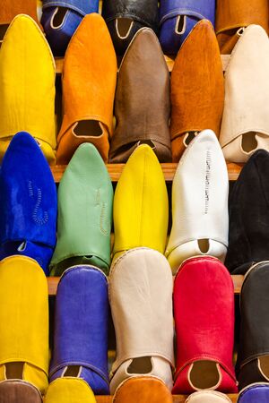 Colors of Marrakesh on sophisticated handmade traditional leather slippers at old medina souk, Moroccoの写真素材