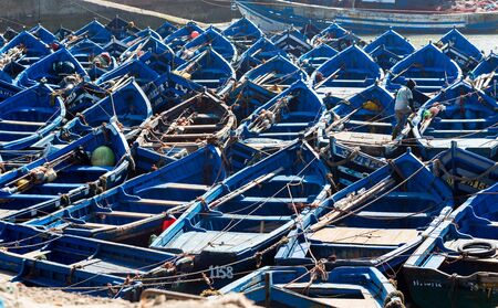 Old wooden blue fishing boats in Essaouira first in the World sardines port. Traditional hand fishing. Full frame cover horizontal cropの写真素材