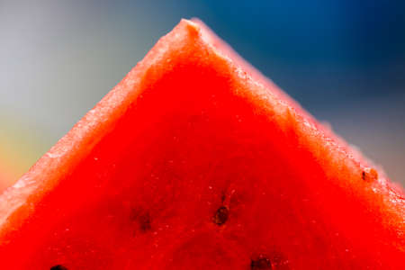 Viibrant red watermelon triangle slices on table close up. Selective focus, shallow depth of field, macroの写真素材