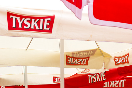 Tyske beer promotion umbrellas in beer garden with displayed logos. Tyskie was founded in 1629. It's part of Asahi Group. Poland, 13/08/2016のeditorial素材