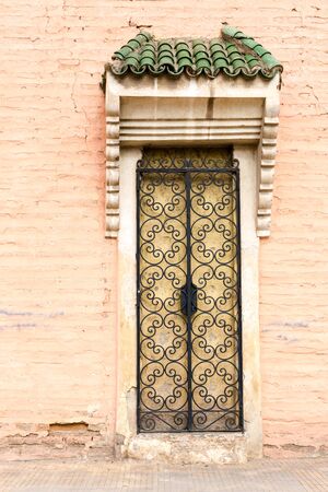 Old traditional islamic door in Moroccan buildings. Straight direct front view.