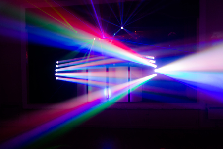 Colourful blurred disco spot lights. Dark composition with stream of lightの写真素材