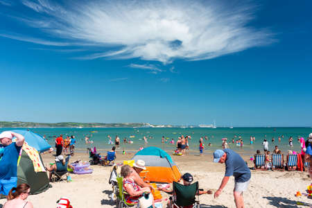 Weymouth beach is full of beach people enjoying hot weather. Weymouth 18.07.2021のeditorial素材