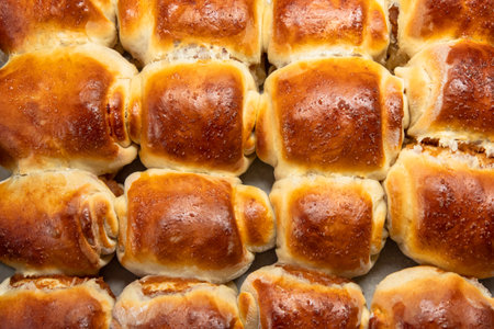 Traditional homemade yeast rolls filled with jam. Close-up on brown tasty home baked pastriesの写真素材
