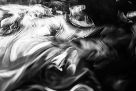 Smoke pipe irregular white smoke on black backgroundの写真素材