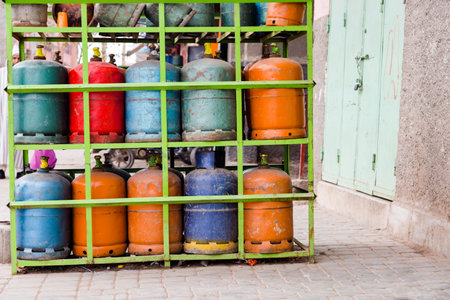 Colourful propane butane gas bottles stored on steel shelf. Natural gas bottles in gas station in Morocco.の写真素材