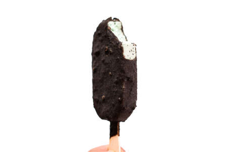 Chocolate cookie and cream crust with mint ice cream bar with wood stick on white background.の写真素材