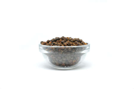 Peppercorns or Black pepper in glass bowl on white background. Cooking ingredients concept.の写真素材