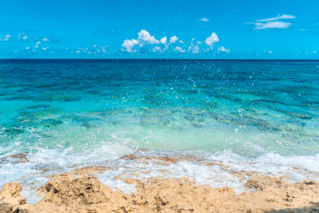 Blue sea water clashing on beautiful beach coast.の写真素材