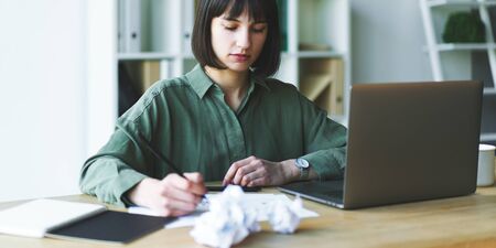 Businesswoman trying to find solution of difficult task