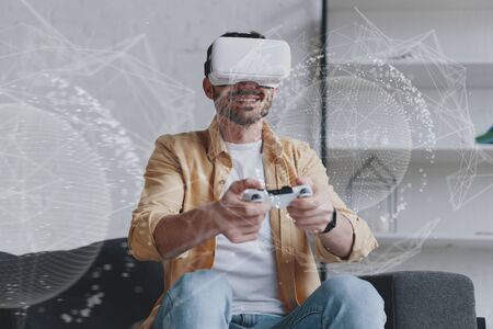 Emotional man in VR glasses playing game with joystick, innovation hologram