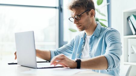 Side view of concentrated at work confident young woman