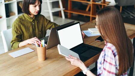 Two young designers women working at homeの写真素材