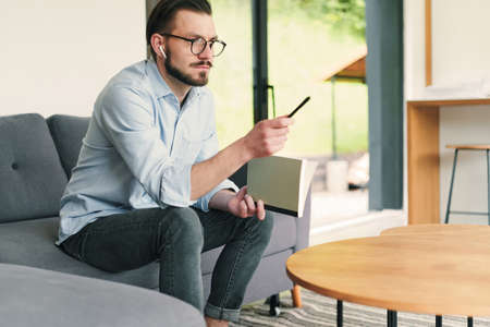 Businessman having online meeting at home