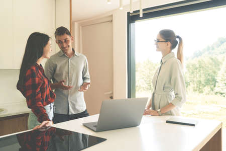 Side view of successful realtor woman talking with clientsの写真素材