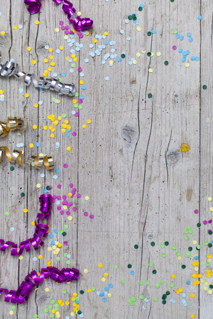 carnival confetti on wood backgroundの写真素材