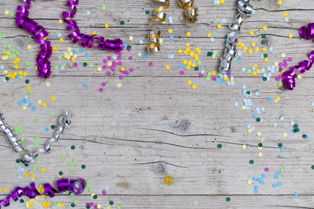 carnival confetti on wood backgroundの写真素材