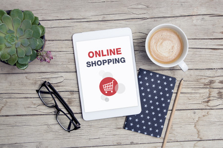 office desk with tablet, handy,notepad and cup of coffeeの写真素材