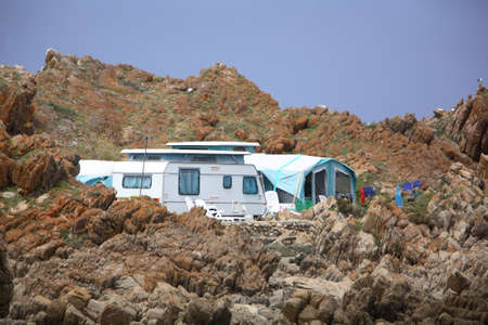 Caravan camping near a rocky seaside shore