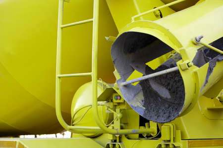 Yellow concrete mixer preparing a cement mix for a building site.の写真素材