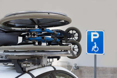 Wheelchair transported on a car's roofの写真素材