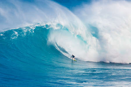 MAUI, HI - MARCH 13: Professional surfer Carlos Burle rides a giant wave at the legendary big wave surf break "Jaws" during one the largest swells of the winter March 13, 2011 in Maui, HI.のeditorial素材