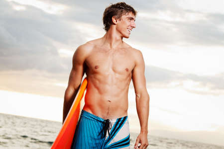 professional surfer holding a surf board