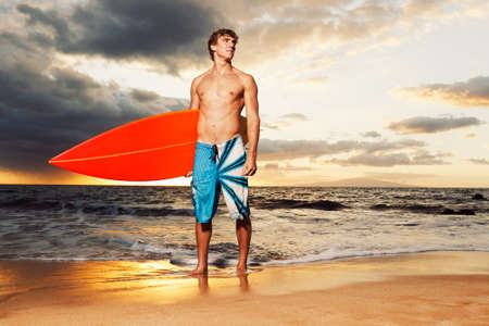 professional surfer holding a surf boardの写真素材