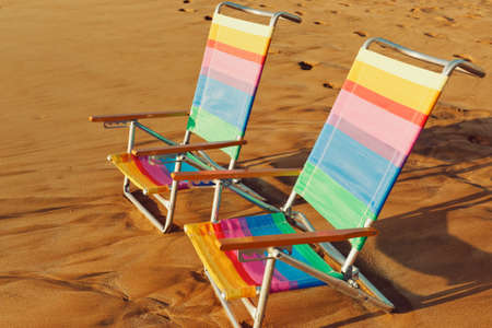 Hawaiian Vacation Sunset Concept, Two Beach Chairs at Sunsetの写真素材