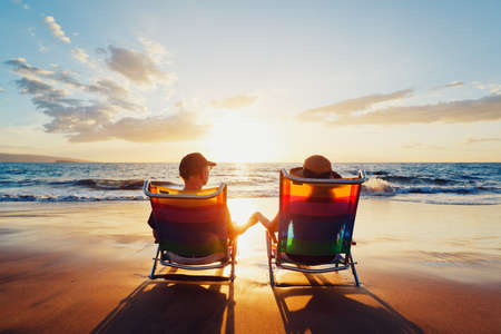 Happy Romantic Couple Enjoying Beautiful Sunset at the Beachの写真素材