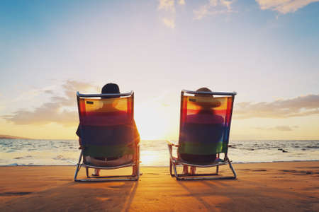 Happy Romantic Couple Enjoying Beautiful Sunset at the Beachの写真素材