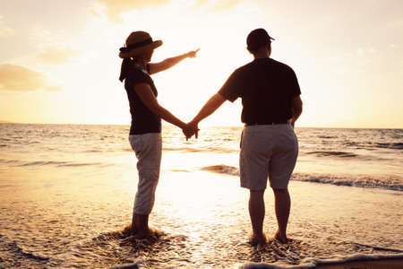 Senior Couple Enjoying Sunset at the Beach