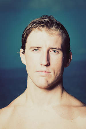 Dramatic Portrait of Handsome Young Fit Man at the Beachの写真素材