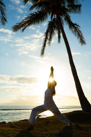 Woman Doing Yoga at Sunsetの写真素材