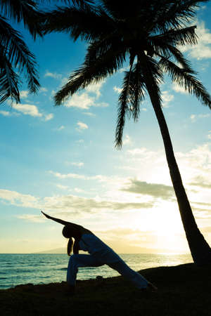 Woman Doing Yoga at Sunsetの写真素材