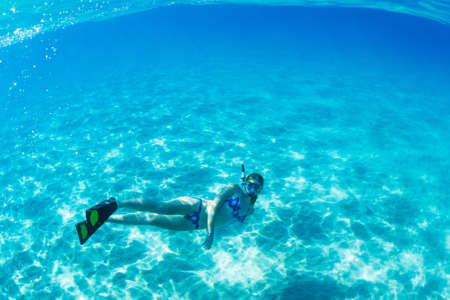 Beautiful Woman Snorkeling in Tropical Oceanの写真素材