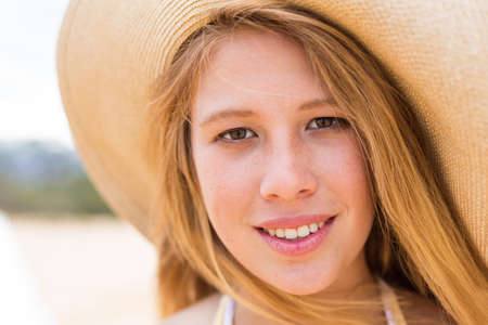 Beautiful Young Woman at the Beach with Vintage Cameraの写真素材