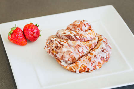 Delicious Cinnamon Roll Sticky Bun with Strawberriesの写真素材