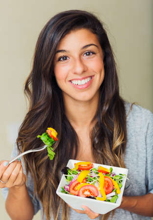 Beautiful healthy woman eating salad, Dieting Concept. Healthy Lifestyle.  の写真素材