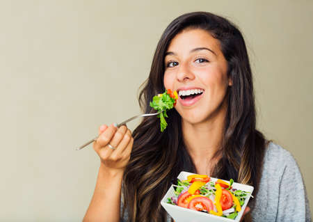 Beautiful healthy woman eating salad, Dieting Concept. Healthy Lifestyle.  の写真素材