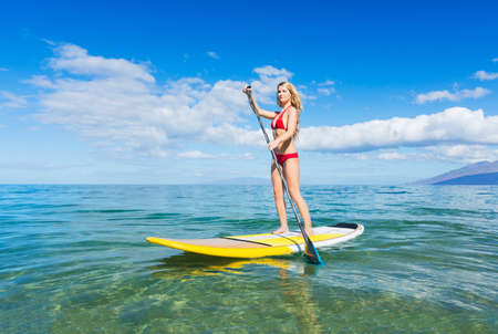 Attractive Woman on Stand Up Paddle Board, SUP, Tropical Blue Ocean, Hawaiiの写真素材