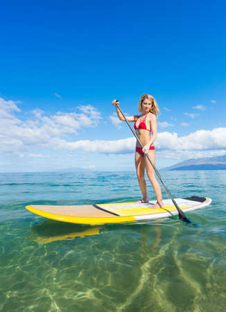 Attractive Woman on Stand Up Paddle Board, SUP, Tropical Blue Ocean, Hawaiiの写真素材
