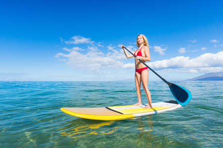 Attractive Woman on Stand Up Paddle Board, SUP, Tropical Blue Ocean, Hawaiiの写真素材
