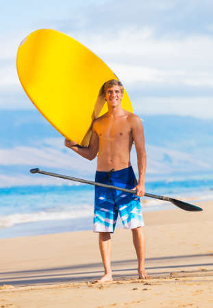 Man with Stand Up Paddle Board, SUP, on the beach in Hawaiiの写真素材
