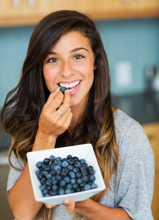Beautiful woman eating blueberries, Healthy Food Lifestyleの写真素材