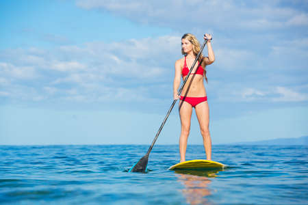Attractive Woman on Stand Up Paddle Board, SUP, Tropical Blue Ocean, Hawaiiの写真素材