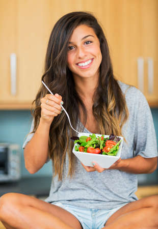 Beautiful healthy woman eating salad, Dieting Concept. Healthy Lifestyle.  の写真素材