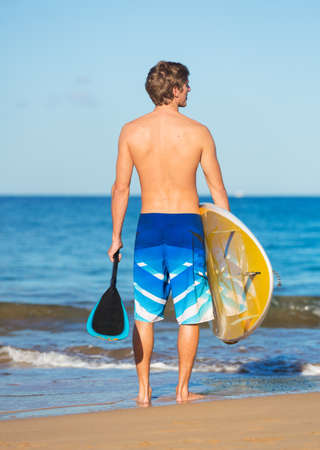 Man with Stand Up Paddle Board, SUP, on the beach in Hawaiiの写真素材